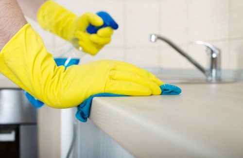 Professional office cleaning tasks including desks, floors, and shared workspace areas