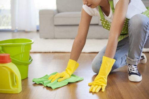 Technician assessing carpet fibres before cleaning in South Kensington